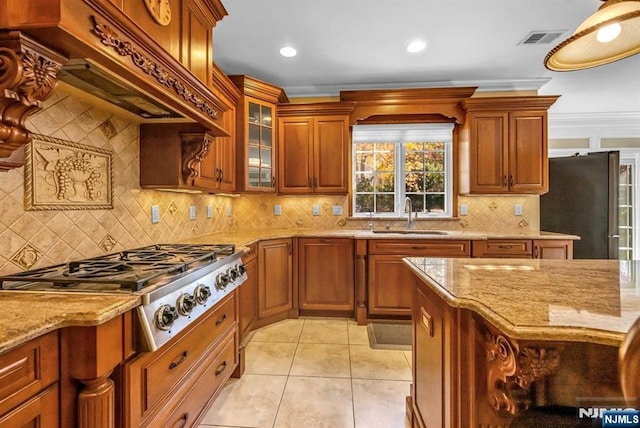 kitchen featuring premium range hood, stainless steel appliances, light stone counters, light tile patterned floors, and sink