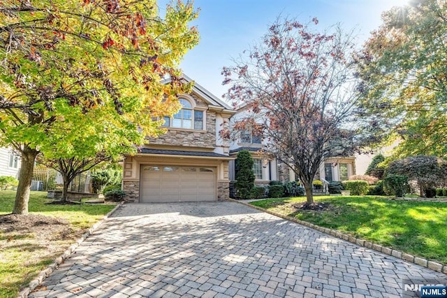 view of front of home with a front yard and a garage