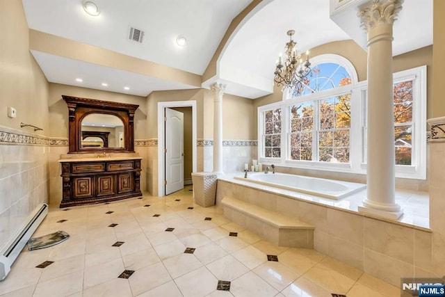 bathroom featuring decorative columns, vanity, tiled tub, a baseboard heating unit, and tile patterned floors