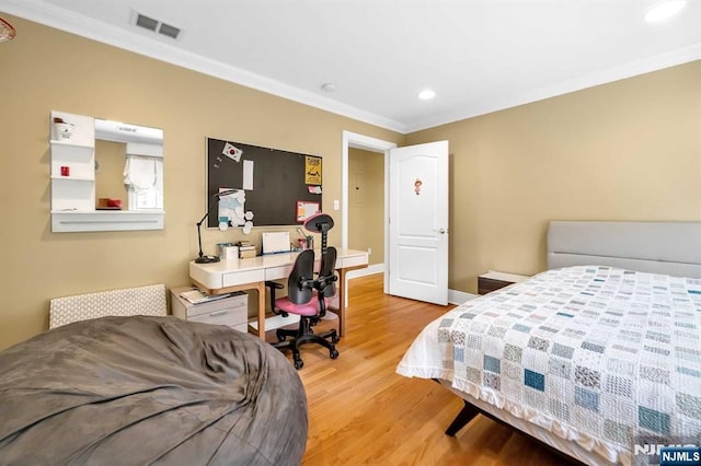 bedroom with ornamental molding and light wood-type flooring