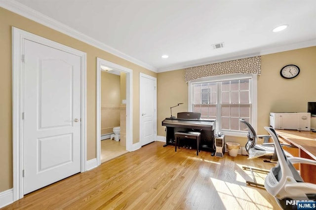 office featuring light wood-type flooring, ornamental molding, and a baseboard heating unit