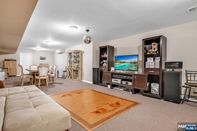 living room featuring an AC wall unit and carpet flooring