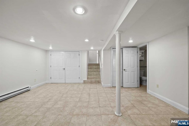 finished below grade area featuring recessed lighting, stairway, a baseboard radiator, and baseboards