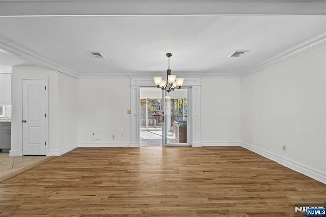 unfurnished dining area with wood finished floors, visible vents, and crown molding