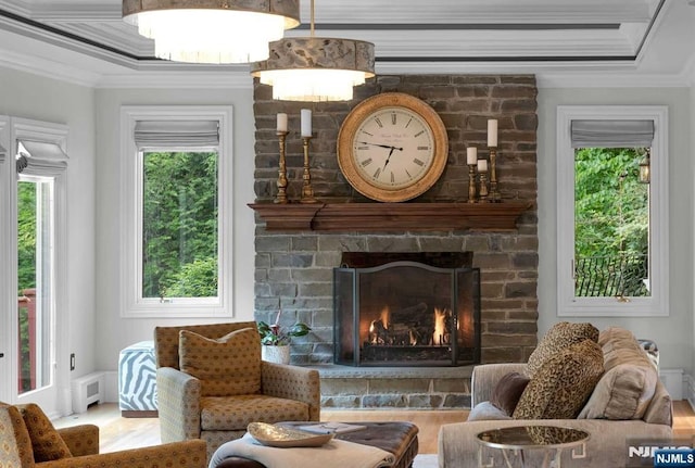 sitting room featuring ornamental molding, a fireplace, and wood finished floors