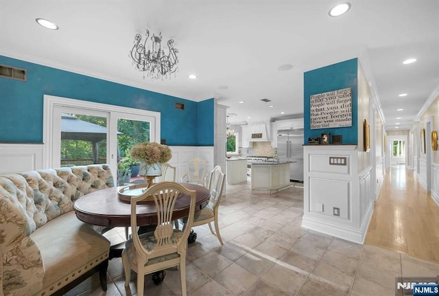 dining area with visible vents, plenty of natural light, and a decorative wall