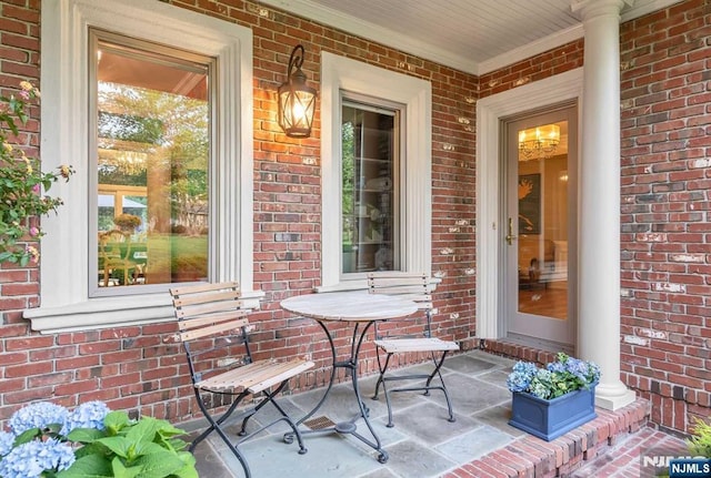 entrance to property featuring brick siding