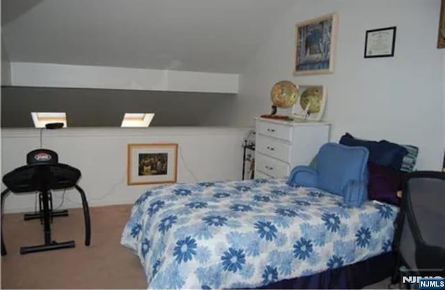 bedroom with vaulted ceiling and carpet floors