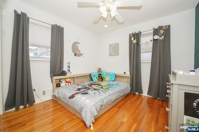 bedroom with hardwood / wood-style flooring and ceiling fan