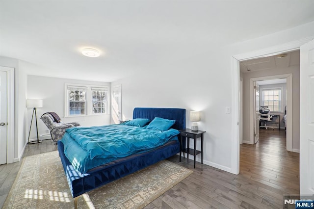 bedroom featuring baseboards and wood finished floors