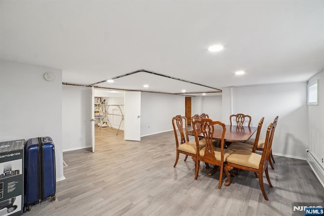 dining space featuring light wood-type flooring, baseboards, baseboard heating, and recessed lighting