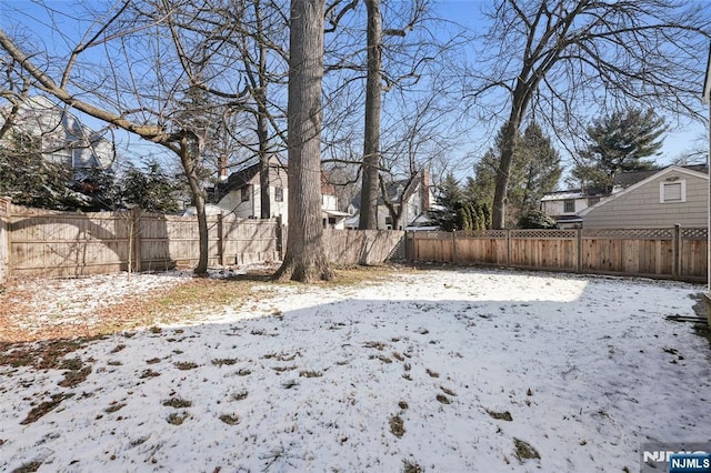 yard layered in snow with fence