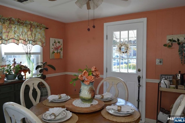 dining space with a wealth of natural light and ceiling fan