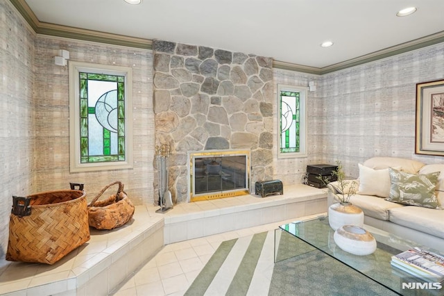 living area featuring ornamental molding, recessed lighting, light tile patterned flooring, and a stone fireplace