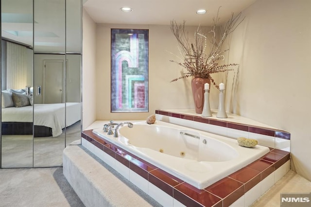 ensuite bathroom featuring recessed lighting, a whirlpool tub, and ensuite bathroom