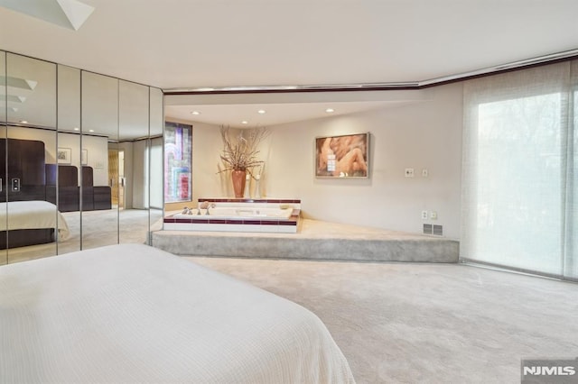 bedroom with recessed lighting, multiple windows, visible vents, and light colored carpet