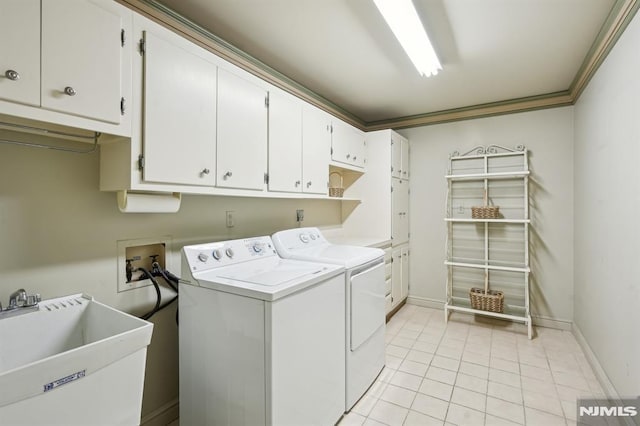 clothes washing area with light tile patterned floors, cabinet space, a sink, separate washer and dryer, and baseboards