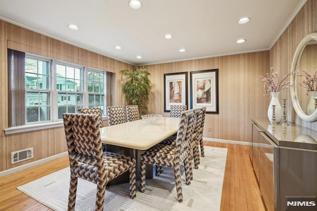 dining space with ornamental molding, light wood-type flooring, visible vents, and recessed lighting