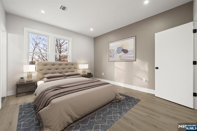 bedroom featuring recessed lighting, visible vents, and wood finished floors