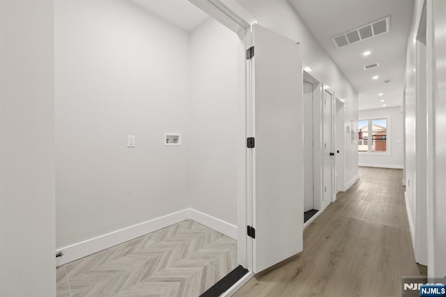 hallway featuring parquet floors, recessed lighting, visible vents, and baseboards