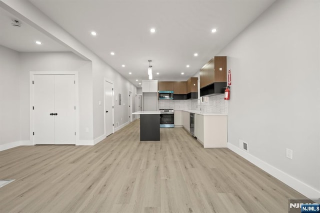 kitchen with light countertops, open floor plan, white cabinetry, a kitchen island, and modern cabinets