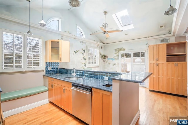 kitchen with light wood-style flooring, a peninsula, a sink, visible vents, and dishwasher