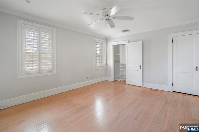 unfurnished bedroom with ornamental molding, baseboards, and light wood finished floors