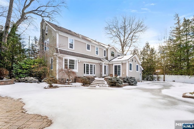 view of front of home with entry steps and a chimney