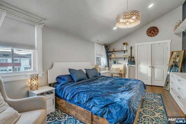 bedroom with vaulted ceiling, wood finished floors, and recessed lighting