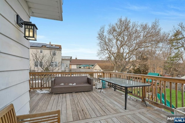 wooden terrace with outdoor dining area