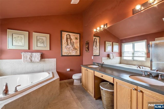 full bathroom featuring lofted ceiling, double vanity, a sink, and a bath