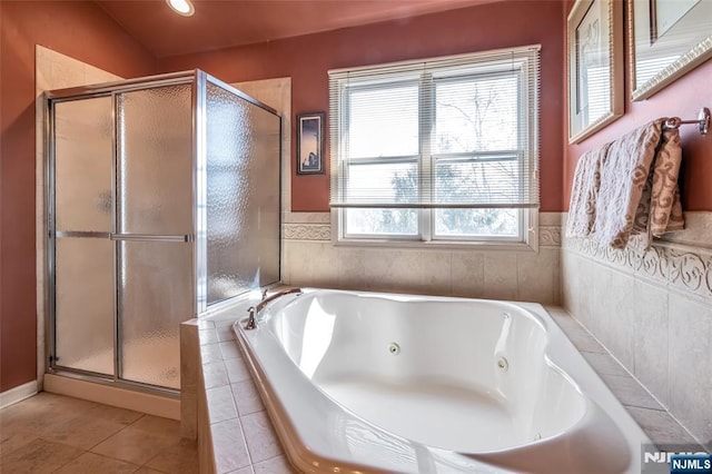 bathroom featuring a jetted tub, a stall shower, and tile patterned floors