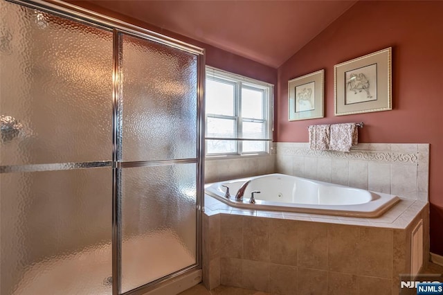 full bath with a stall shower, a garden tub, and vaulted ceiling