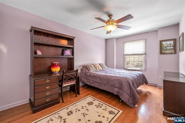 bedroom featuring baseboards, a ceiling fan, and light wood-style floors