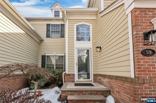 property entrance with brick siding