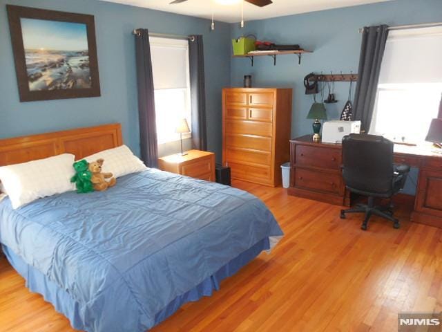 bedroom with light wood-style flooring and a ceiling fan