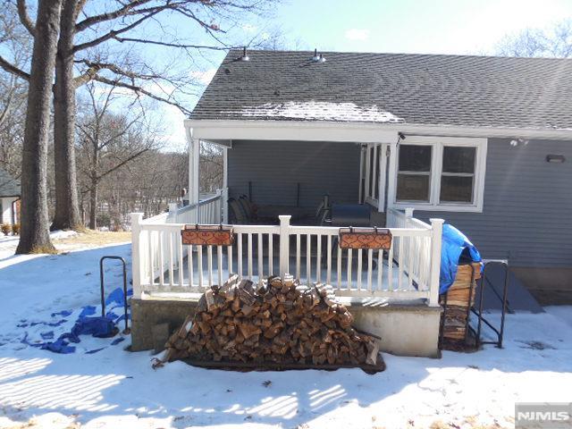 exterior space featuring roof with shingles