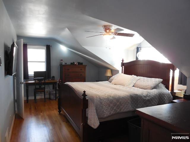 bedroom with lofted ceiling, wood finished floors, and a ceiling fan