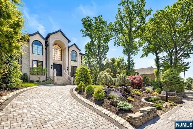 view of front of property with decorative driveway and stucco siding