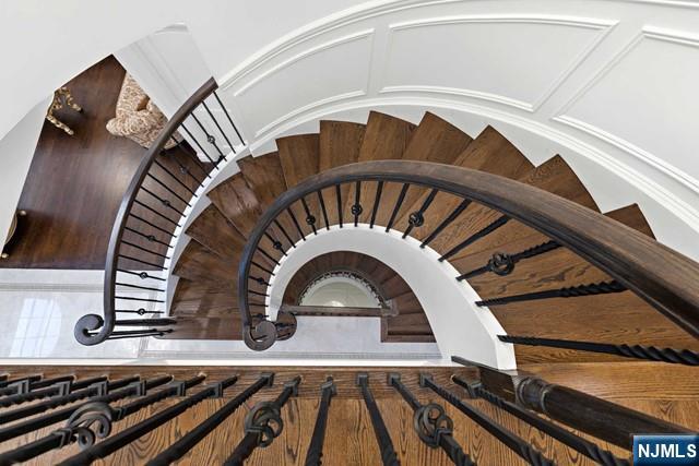 staircase with a decorative wall and arched walkways