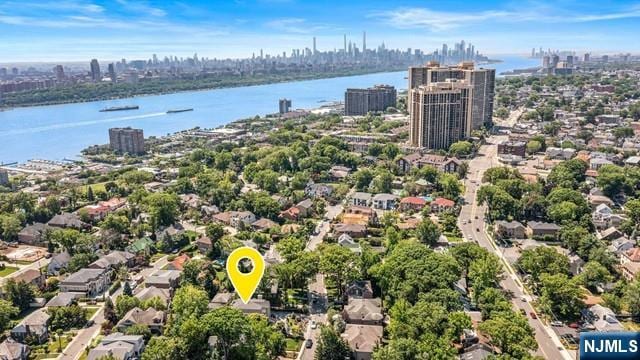 drone / aerial view featuring a city view and a water view