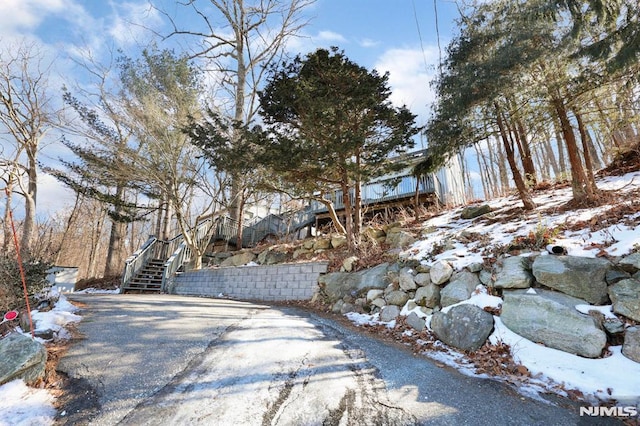 view of road featuring stairs and aphalt driveway