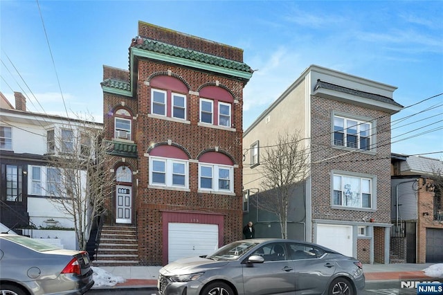 view of front of property featuring a garage and brick siding