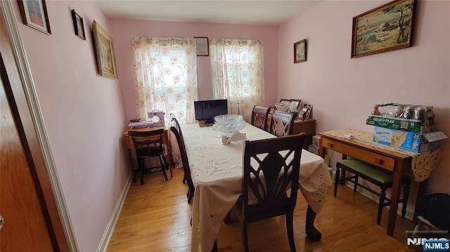 dining room with light wood-style floors and baseboards