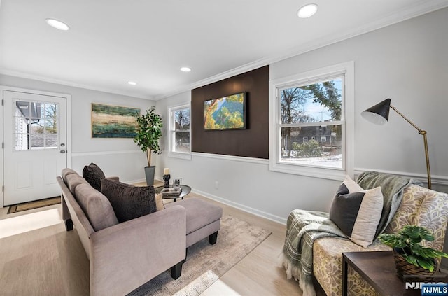 living area with a healthy amount of sunlight, ornamental molding, and recessed lighting