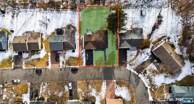 snowy aerial view with a residential view