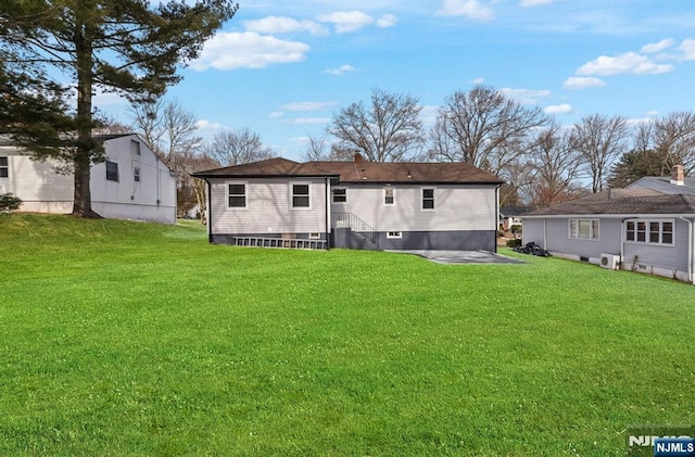 back of house featuring a yard