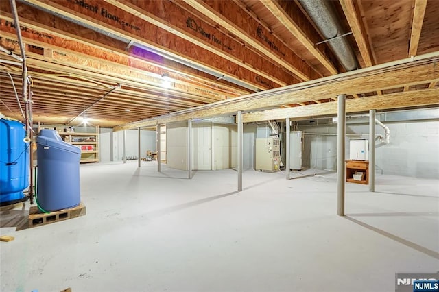 basement featuring water heater and heating unit