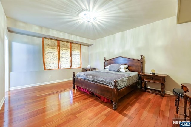 bedroom featuring baseboards and hardwood / wood-style floors