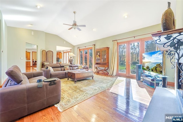 living room featuring wood finished floors, french doors, a ceiling fan, and lofted ceiling